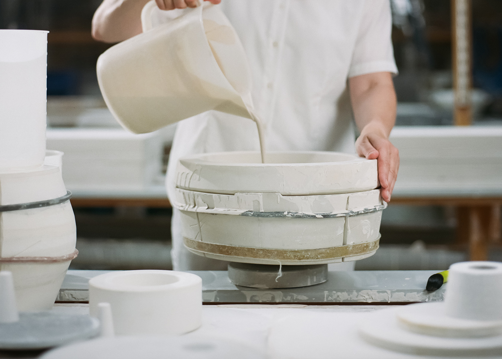The mould is being filled with porcelain